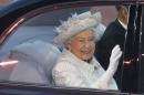 Britain's Queen Elizabeth waves as she arrives during the opening ceremony for the 2014 Commonwealth Games at Celtic Park in Glasgow, Scotland