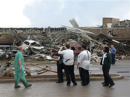 People look at the destruction after a huge tornado struck Moore, Oklahoma