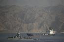 An Israeli Navy boat escorts the Panamanian-flagged cargo vessel Klos C into the Israeli port of Eilat on Saturday after seizing it in the Red Sea on Wednesday