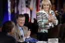 Oklahoma Gov. Mary Fallin, right, and Colorado Gov. John Hickenlooper, center, applaud Tennessee Gov. Bill Haslam, left, during the closing session of the National Governors Association convention Sunday, July 13, 2014, in Nashville, Tenn. (AP Photo/Mark Humphrey)