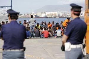 Migrants are disembarked from the Migrant Offshore Aid Station (MOAS) ship MV Phoenix in the Sicilian harbour of Messina