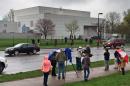 FILE - In this April 21, 2016 file photo, people stand outside entertainer Prince's Paisley Park compound in Chanhassen, Minn. Court filings in Prince's estate show that a special administrator, and likely Prince's siblings, are eager to explore the money-making potential of making a tourist attraction out of his Paisley Park home and studio complex. (Jim Gehrz/Star Tribune via AP, File) MANDATORY CREDIT; ST. PAUL PIONEER PRESS OUT; MAGS OUT; TWIN CITIES LOCAL TELEVISION OUT TV is soft out