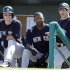 New York Yankees manager Joe Girardi, right, watches from the dugout along side Eduardo Nunez, center, and Jayson Nix during the second inning of an exhibition spring training baseball game against the Miami Marlins Friday, March 8, 2013, in Jupiter, Fla. The Marlins won 6-1. (AP Photo/Jeff Roberson)