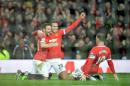 Manchester United's Robin van Persie (2-L) celebrates scoring their third goal with Juan Mata and Wayne Rooney (R) during the English Premier League football match against Liverpool at Old Trafford on December 14, 2014