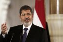 FILE - In this Friday, July 13, 2012 file photo, Egyptian President Mohammed Morsi holds a joint news conference with Tunisian President Moncef Marzouki, unseen, at the Presidential palace in Cairo, Egypt. In a posting Saturday, April 20, 2013 on his official Twitter account, Morsi promised to reshuffle the Cabinet and appoint new governors. (AP Photo/Maya Alleruzzo, File)