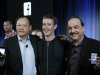 From left, HTC CEO Peter Chou, Facebook CEO Mark Zuckerberg and AT&T Mobility CEO Ralph De La Vega embrace as they show joint products at Facebook headquarters in Menlo Park, Calif., Thursday, April 4, 2013. (AP Photo/Marcio Jose Sanchez)