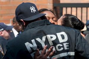 NYPD officers embrace after the body of NYPD officer &hellip;