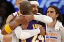 New York Knicks forward Carmelo Anthony (7) embraces Los Angeles Lakers forward Kobe Bryant (24) at the end of an NBA basketball game at Madison Square Garden in New York, Sunday, Nov. 8, 2015. The Knicks defeated the Lakers 99-95. (AP Photo/Kathy Willens)