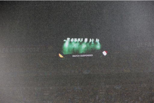 A match suspension is advised on a giant screen seen through a heavy rain during the Euro 2012 soccer championship Group D match between Ukraine and France in Donetsk, Ukraine, Friday, June 15, 2012. (AP Photo/Matthias Schrader)
