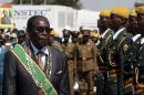 President Mugabe walks past soldiers as he arrives for Zimbabwe's Heroes Day commemorations in Harare