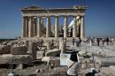 Tourists visit the Parthenon Temple at the Acropolis hill in Athens on October 12, 2014, where the Elgin Marbles were located before they were removed from the city in the 19th century