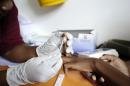 A nurse takes a blood sample in a mobile clinic set up to test students for HIV in Kwazulu Natal, South Africa on March 8, 2011