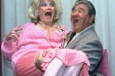 FILE-In this Oct. 9, 1985, file photo, Comedian Phyllis Diller gets a lift from emcee Buddy Hackett prior to the celebrity stag luncheon roast at the New York Friars Club in New York City. Diller, the housewife turned humorist who aimed some of her sharpest barbs at herself, died Monday, Aug. 20, 2012, at age 95 in Los Angeles.(AP Photo/Marty Lederhandler, File)