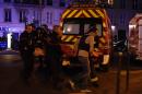 Rescuers workers evacuate victims near the Bataclan concert hall in central Paris, on November 13, 2015