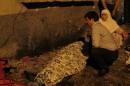 A man and a woman mourn next to a body of one the victims of a blast targeting a wedding ceremony in the southern Turkish city of Gaziantep
