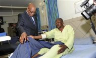 South Africa's President Jacob Zuma (L) chats with one of the injured miners during a courtesy visit in a hospital outside a South African mine in Rustenburg, 100 km (62 miles) northwest of Johannesburg, August 17, 2012. REUTERS/Kopano Tlape/Government Communications and Information Systems (GCIS)/Handout