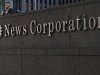 A passer-by stands in front of the News Corporation building in New York