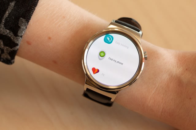 Photo of a wrist with a watch displaying some icons and text