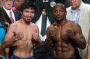 Boxers Manny Pacquiao (L) and Timothy Bradley Jr. weigh-in for their bout at the MGM Grand Arena in Las Vegas, Nevada on April 8, 2016