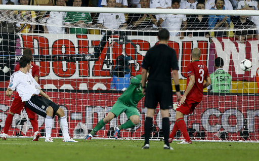 Germany's Mario Gomez, left front, scores during the Euro 2012 soccer championship Group B match between Germany and Portugal in Lviv, Ukraine, Saturday, June 9, 2012. (AP Photo/Frank Augstein)