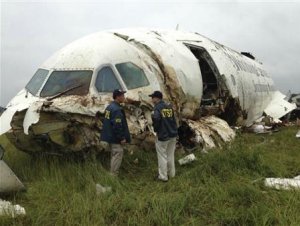NTSB handout shows inspectors survey the wreckage of …