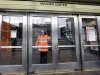 An MBTA transit official closes a door at Malden Center station in Malden, Mass. Friday, April 18, 2013 as area MBTA commuter trains are suspended. In Boston, authorities suspended all mass transit and urged close to a million people in all of Boston and some of its suburbs to stay indoors as they searched for the remaining suspect in the Boston Marathon bombing. Businesses were asked not to open Friday. People waiting at bus and subway stops were told to go home. (AP Photo/Elise Amendola)