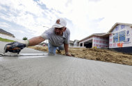 FILE - In this Thursday, Aug. 1, 2013, file photo, a sidewalk gets shaped in front of new construction in Omaha, Neb._The Commerce Department reports on new-home sales for August on Wednesday, Sept. 25, 2013. (AP Photo/Nati Harnik)