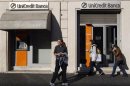 People are seen in front of a Unicredit bank in Rome
