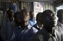 Supporters of Kenyan PM Odinga watch election results on television in Nairobi