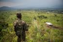A soldier from the armed forces of the Democratic Republic of the Congo stands guard on a hill overlooking a UN tank in the restive North Kivu province on July 11, 2012