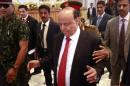 Yemen's President Abd-Rabbu Mansour Hadi enters hall during closing ceremony of the national dialogue conference, in Sanaa