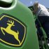 FILE - In this photo July 29, 2010 file photo, a farmer climbs aboard a John Deere 9770 STS combine near Coy, Ark.  Deere & Co. is expected to report quarterly results Wednesday, May 15, 2013. (AP Photo/Danny Johnston, File)