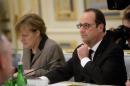 French President Francois Hollande and German Chancellor Angela Merkel, left, attend a meeting with Ukrainian President Petro Poroshenko in Kiev, Ukraine, Thursday, Feb. 5, 2015. The leaders of France and Germany proposed a new peace plan Thursday to end the fighting in eastern Ukraine, fueling fears the conflict is threatening Europe's overall security. (AP Photo/Efrem Lukatsky)