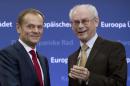 Outgoing European Council President Herman Van Rompuy, right, prepares to give incoming European Council President Donald Tusk a bell during a handover ceremony for the European Council Presidency at the EU Council building in Brussels on Monday, Dec. 1, 2014. Poland's former prime minister Donald Tusk is pushing the EU's center of political gravity eastward by taking over the EU Presidency from Belgium's Herman Van Rompuy. Monday's transition ceremony highlighted the increasing power of Poland within the 28-nation EU and further shift from a west European economic association to a strong political body uniting some 500 million people from Britain to the borders of Russia in the east. (AP Photo/Virginia Mayo)