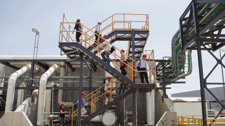 In this Sunday, May 4, 2014 photo, workers climb stairs at the Sorek desalination plant in Rishon Letzion, Israel. Israel&#39;s aggressive desalination program that has transformed this perennially parched country into perhaps the most well-hydrated country in the region. (AP Photo/Dan Balilty)