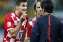 Croatia's Dejan Lovren, left, and teamamte Ivan Rakitic, center, complain to referee Yuichi Nishimura, from Japan, after Nishimura issued a penalty against Croatia during the group A World Cup soccer match between Brazil and Croatia in the opening game of the tournament at Itaquerao Stadium in Sao Paulo, Brazil, Thursday, June 12, 2014. Brazil's Neymar scored on a penalty kick following the ball helping his team to a 3-1 victory. (AP Photo/Frank Augstein)