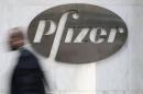 A man walks past Pfizer's world headquarters in New York