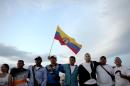 Members of the Colombian Revolutionary Armed Forces of Colombia (FARC) guerrilla attend the broadcasting of the signing of the peace at El Diamante rebel camp, Caqueta department, Colombia