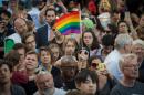 People wave flags during a vigil in reaction to the mass shooting at a gay nightclub in Orlando, Florida, in New York on June 12, 2016
