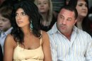 FILE - This Sept. 13, 2009 file photo originally released by Oral-B Pulsonic shows "Real Housewives of New Jersey" stars, Teresa Giudice, left, and her husband Joe Giudice at the Caravan Fashion Show sponsored by Oral-B Pulsonic in New York. Teresa and Giuseppe 