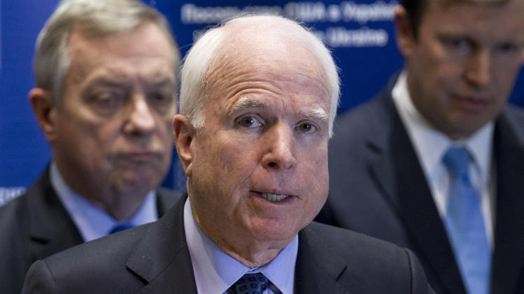 U.S. Sen. John McCain, R-Ariz., center, speaks during a news conference in Kiev, Ukraine, Saturday, March 15, 2014. McCain and a team of seven other senators concluded their visit in Kiev on Saturday with a news conference in which they reaffirmed their support to the interim Ukrainian government. (AP Photo/David Azia)