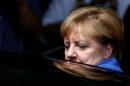 German Chancellor Merkel leaves a news conference in Berlin