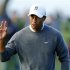 U.S. golfer Tiger Woods waves to fans after making par on the fifth hole during the fourth round play at the Farmers Insurance Open in San Diego