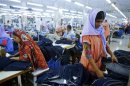 Workers sort clothes at a garment factory near the collapsed Rana Plaza building in Savar
