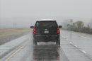 In this Nov. 2, 2011, photo a black SUV carrying Iowa Gov. Terry Branstad, and a police escort, unseen in front, travel a reopened stretch of Interstate 680 that had been closed by flooding. A trooper pursued the same state vehicle carrying Iowa Gov. Terry Branstad on April 26 that was speeding 90 miles per hour on an Iowa highway, but declined to pull the driver over after realizing who was in the vehicle, according to records released Tuesday, July 2, 2013.. (AP Photo/Nati Harnik)