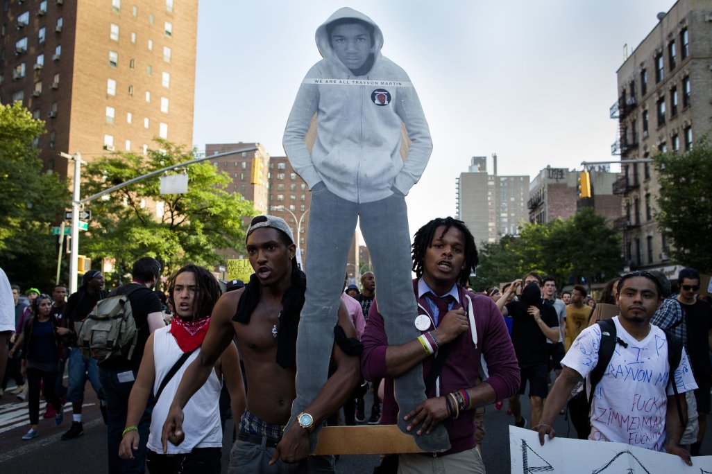 Demonstrators march through the Lower East Side neighborhood of Manhattan in New York, Sunday, July 14, 2013, holding a cut-out of Trayvon Martin during a protest against the acquittal of neighborhood watch member George Zimmerman in the killing of the 17-year-old in Florida. Demonstrators upset with the verdict protested mostly peacefully in Florida, Milwaukee, Washington, Atlanta and other cities overnight and into the early morning. (AP Photo/John Minchillo)