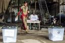 A voter prepares to cast her ballot at a polling station in Conakry