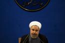 Iranian President Hassan Rouhani listens during a press conference in Tehran on June 13, 2015