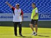 Liverpool's Rodgers gestures beside Cole during his team's practice session in Toronto