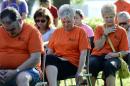 Teen Challenge member, Carol Parker, center, becomes emotional during a memorial service at River Park Saturday, July 18, 2015, in Chattanooga, Tenn., for the victims of the Tennessee shootings. The U.S. Navy says a sailor who was shot in the attack on a military facility in Chattanooga has died, raising the death toll to five people. (AP Photo/Mark Zaleski)